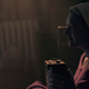 June (Elisabeth Moss) listens to some music before recording a secret message for Luke.